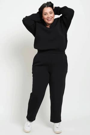 a model wearing black pants with a matching long sleeve top