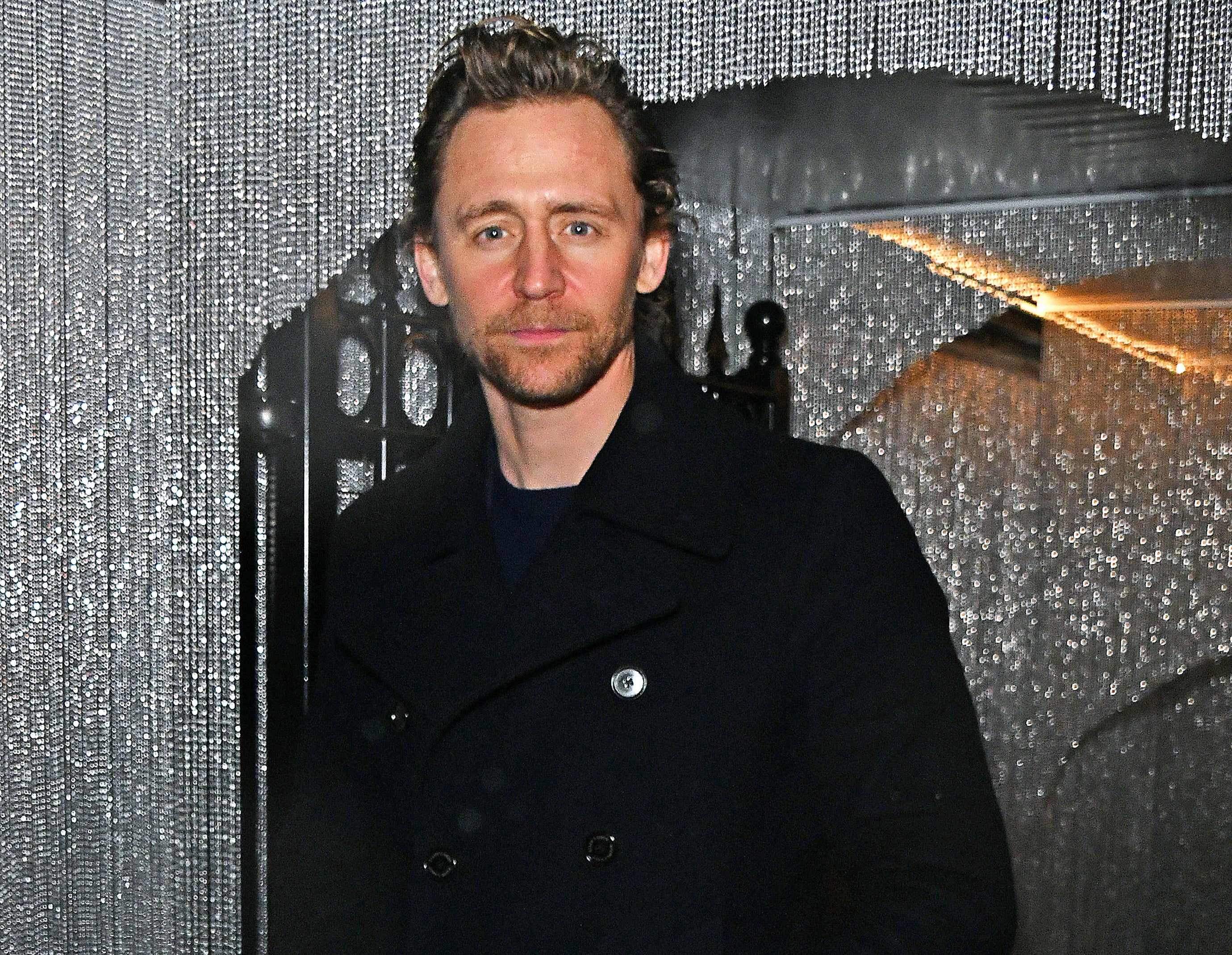 A close-up of Tom in a coat