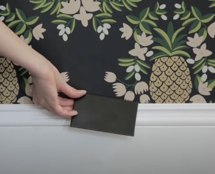 Holding up color against a pineapple wallpaper