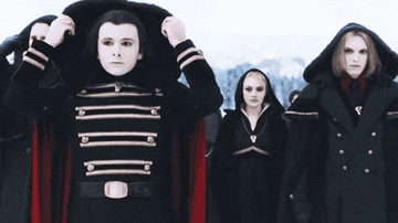 GIF group of cloaked vampires taking cloaks off