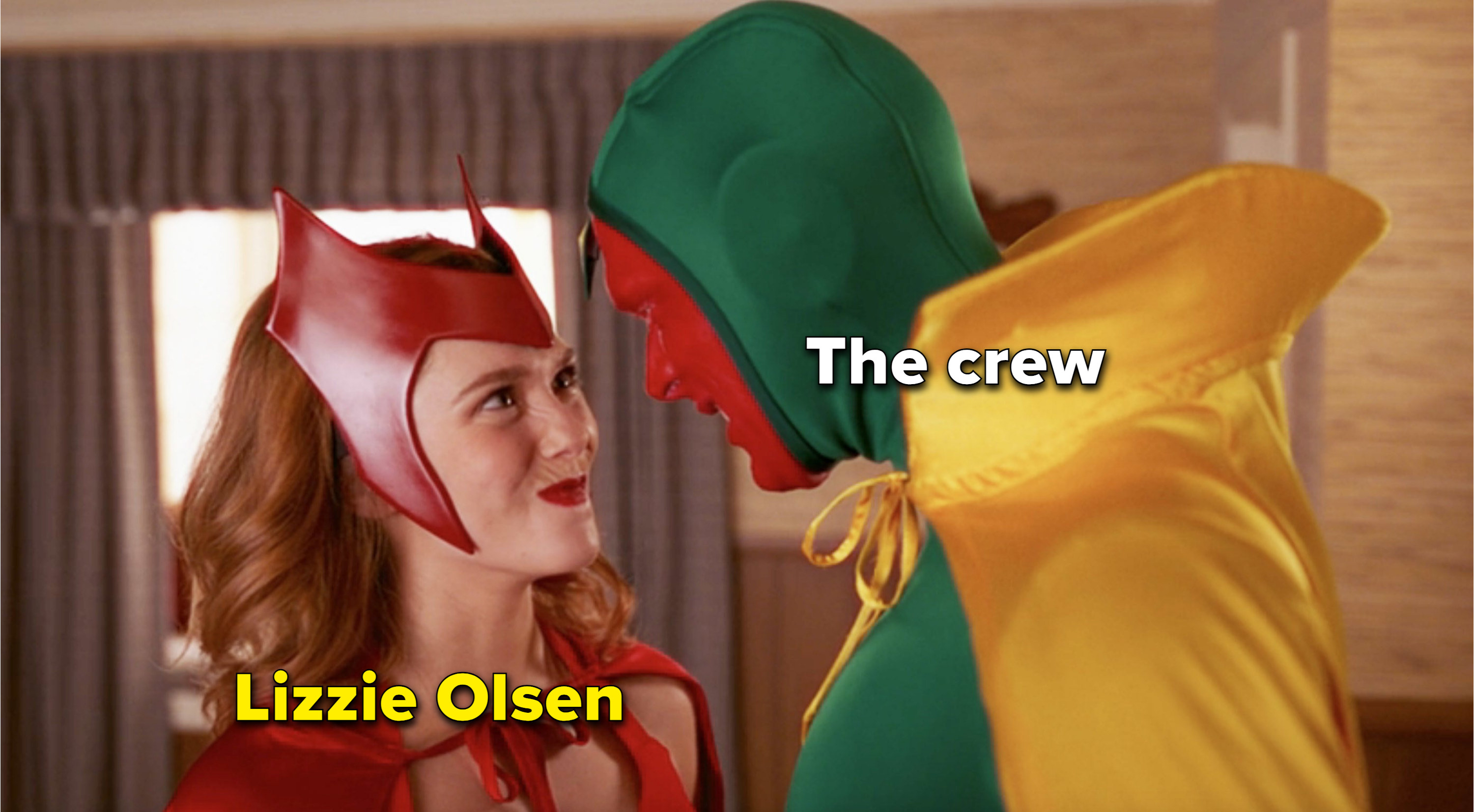 A meme of Wanda and Vision smiling lovingly at each other, with Wanda labeled &quot;Lizzie Olsen&quot; and Vision labeled &quot;the crew&quot;