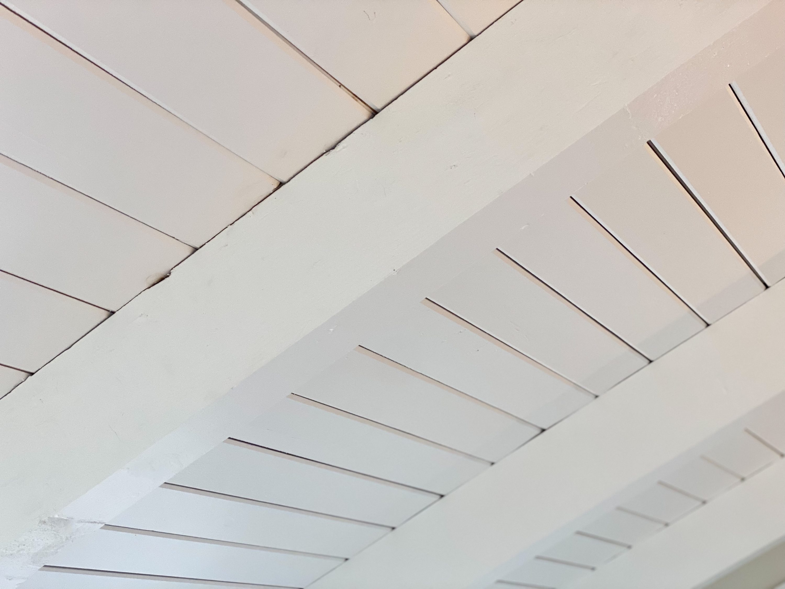 White painted wood beams on ceiling