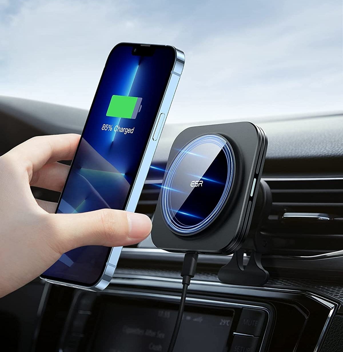 A person putting their phone onto the magnetic mount in the car