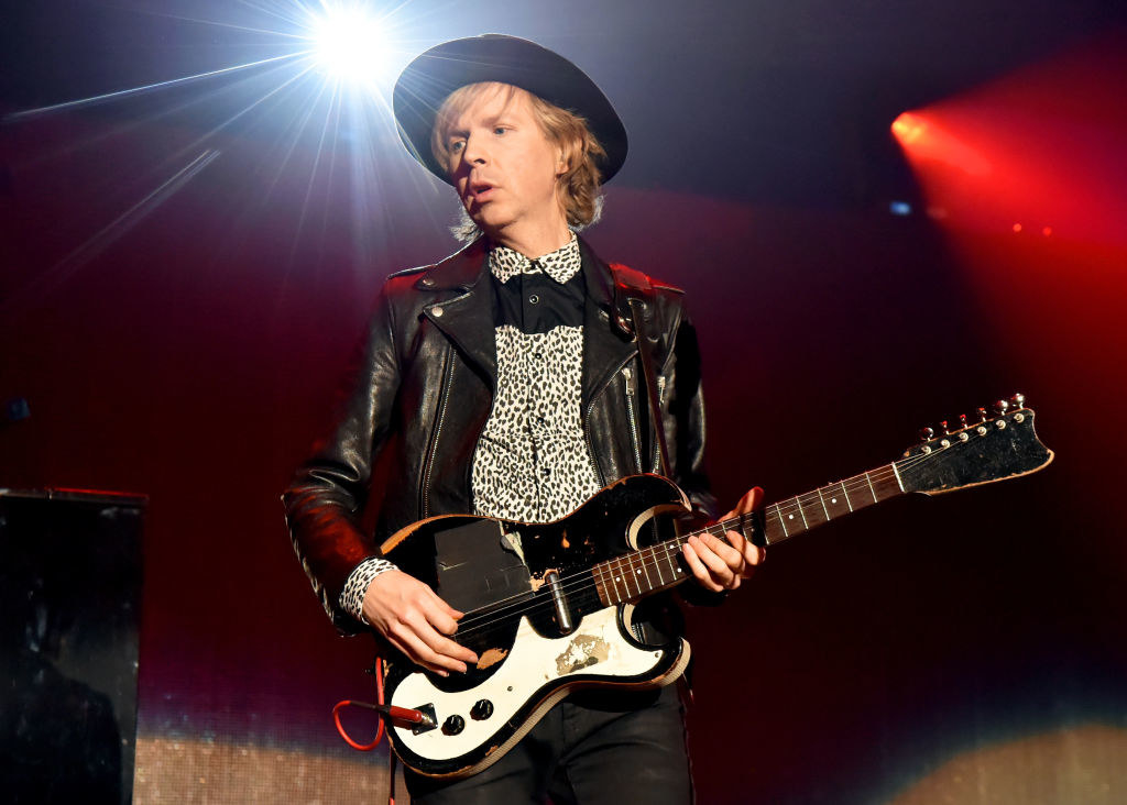 Beck plays guitar onstage