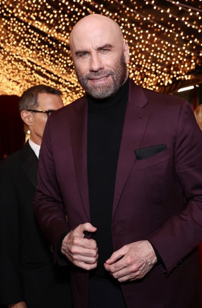 John Travolta smiles at an event
