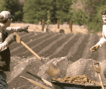GIF of Mose in a field throwing manure at Dwight.