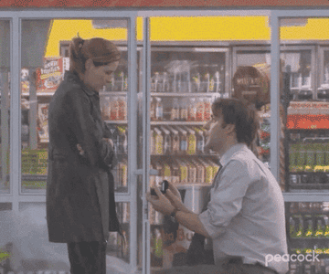 GIF of Jim on one knee, proposing to Pam in the rain.