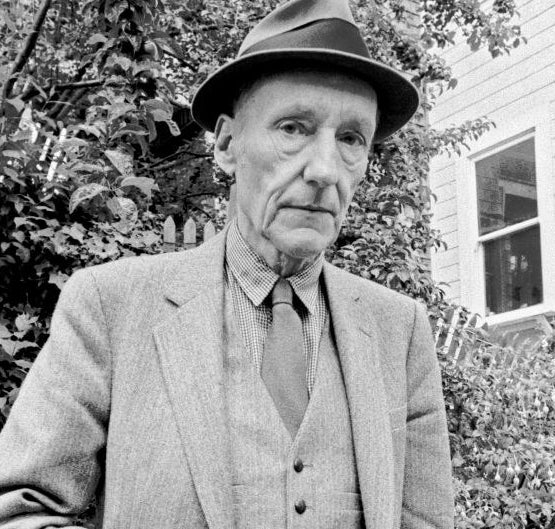 William S Burroughs looks straight at the camera