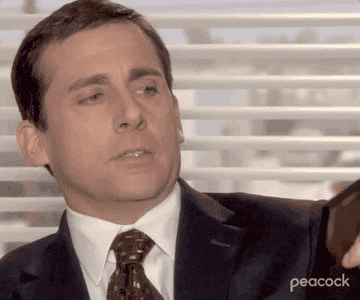 GIF of Michael Scott holding a photo of him and David Wallace.