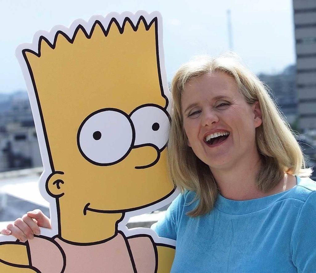 Nancy Cartwright poses with a life-size cutout of Bart Simpson