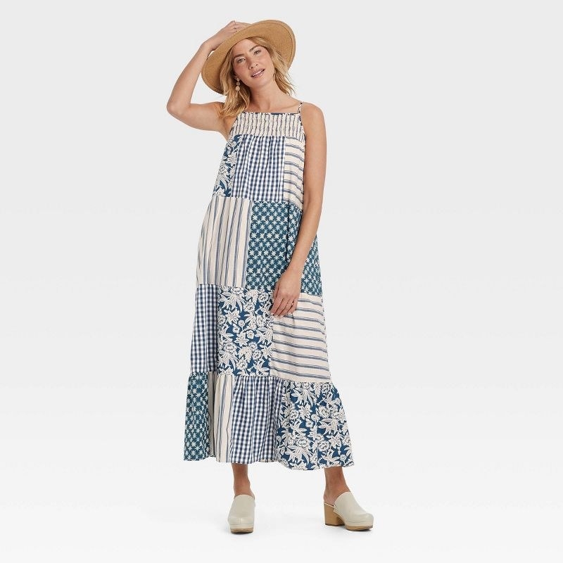 Model wearing blue-and-white patchwork maxi dress