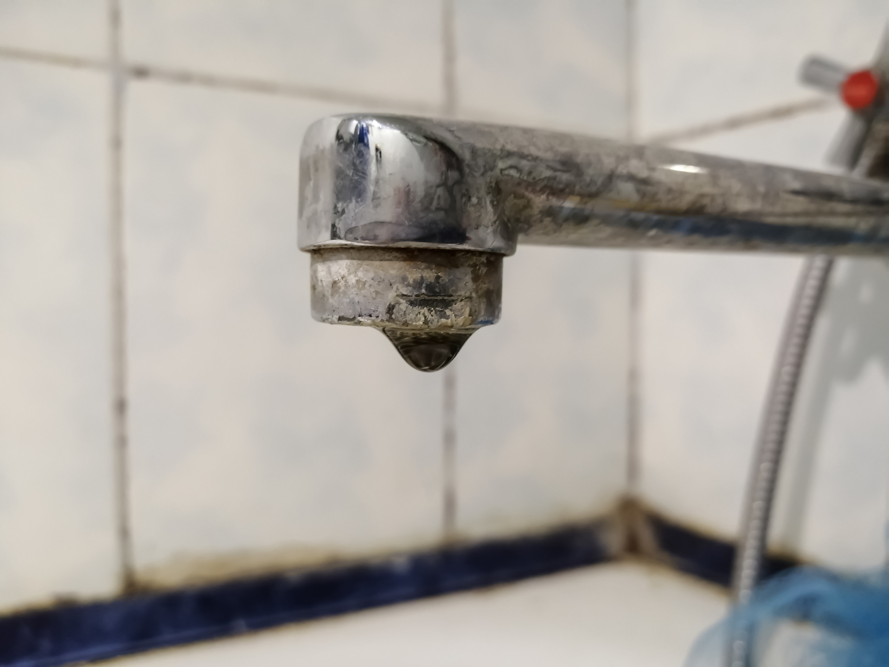 dripping faucet in weathered bathroom