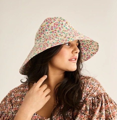 A person wearing the hat while looking to the side