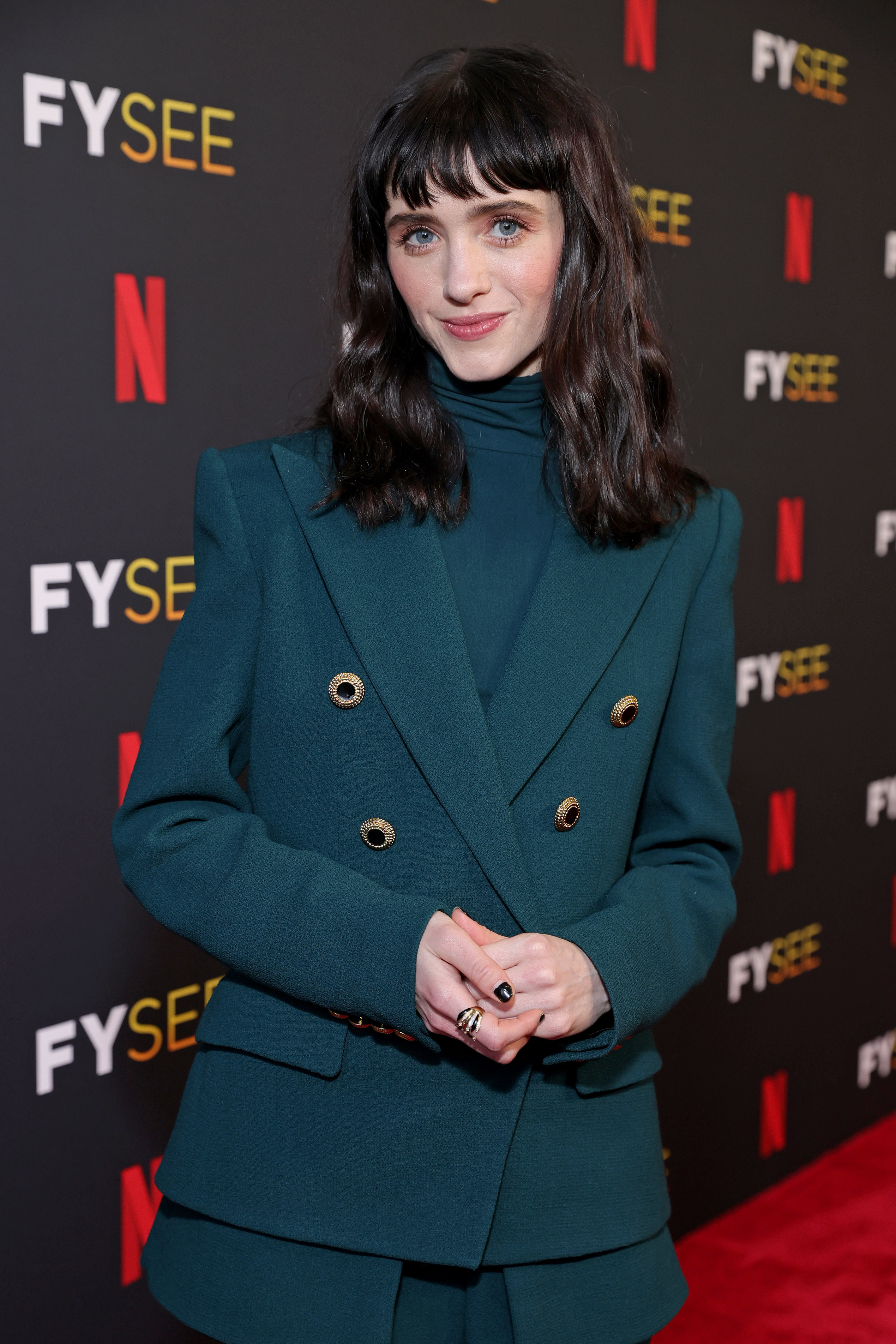 Natalia Dyer dressed in a suit at a Netflix event