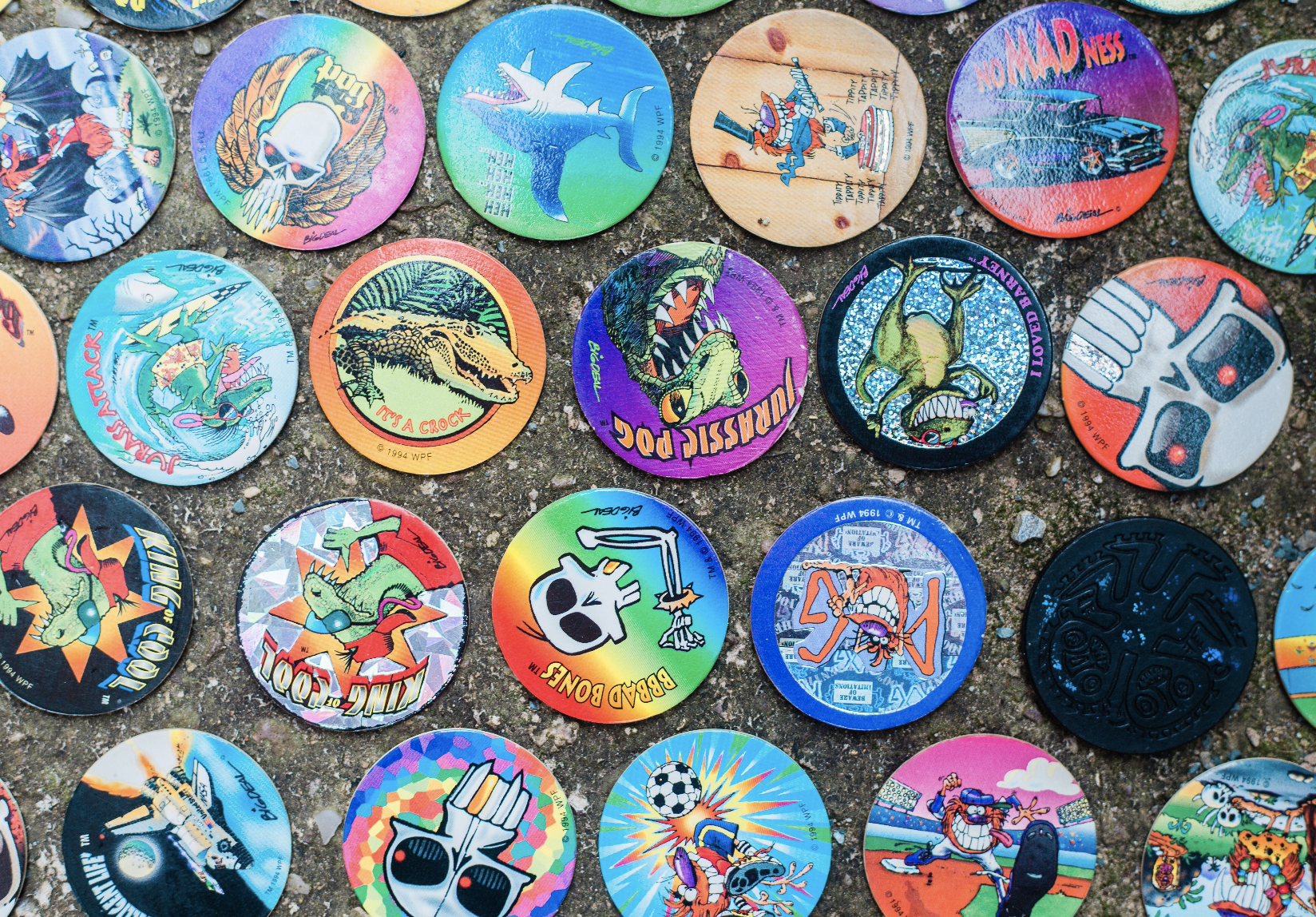 a bunch of colorful circular pogs