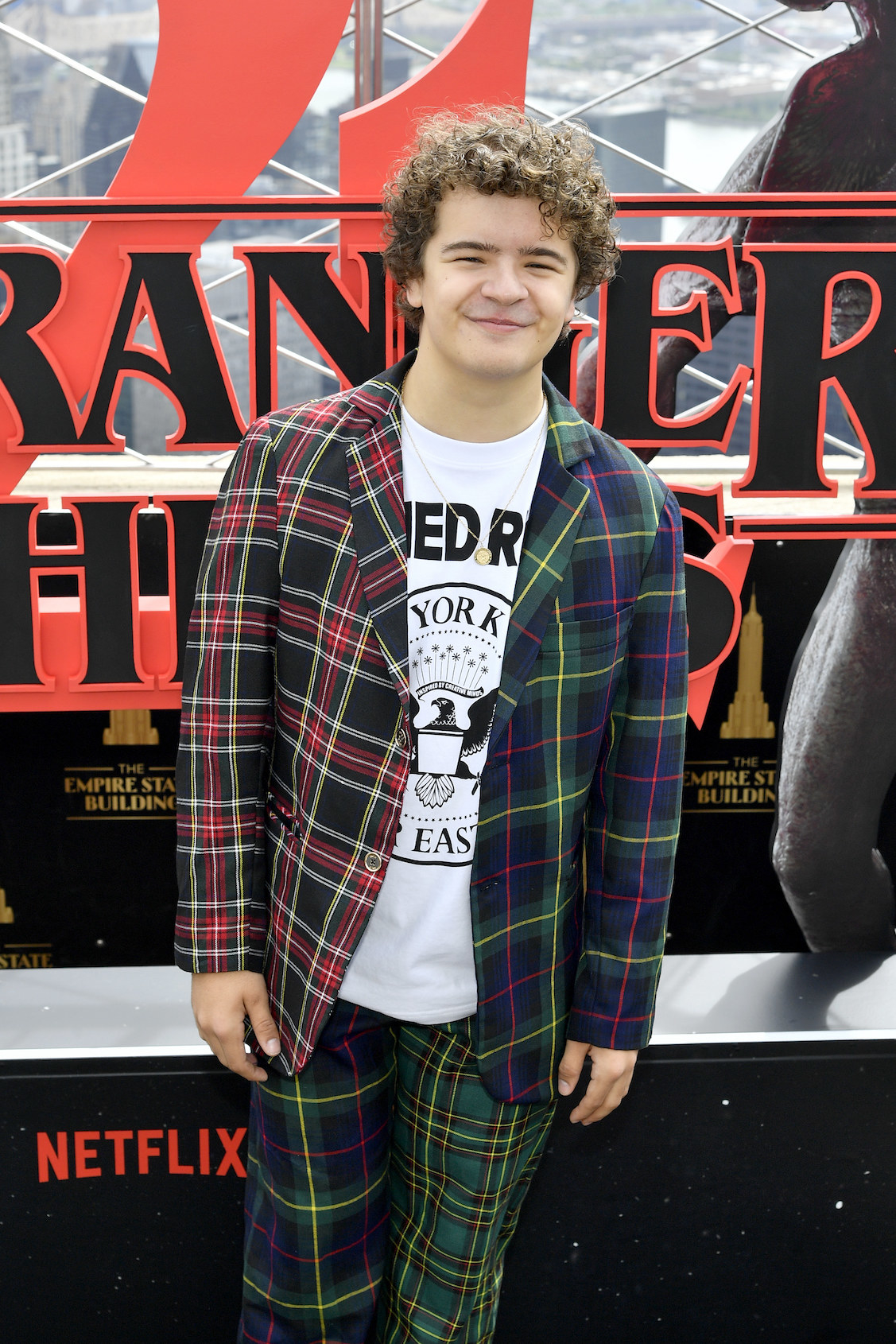 Gaten Matarazzo in a plaid suit at a Netflix event