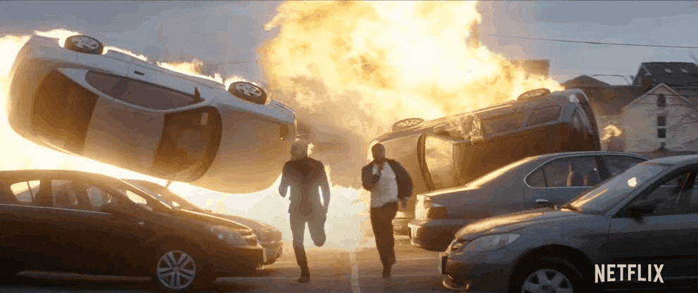 A gif of action from the movie include cars blowing up and people running and people jumping through windows