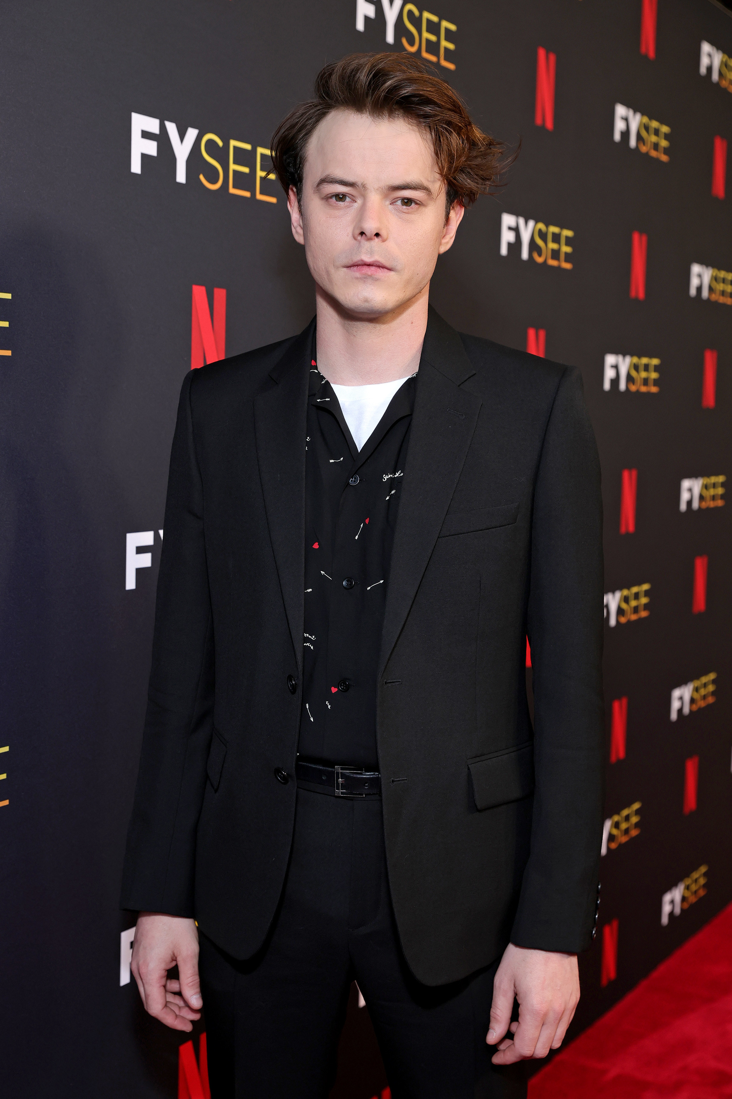 Charlie Heaton wearing a suit at a Netflix event