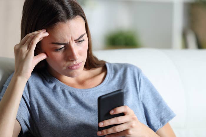A woman looking concerned while she's on her phone