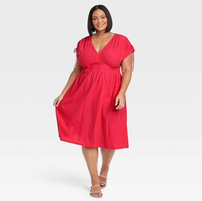 A model wearing a red short sleeve dress