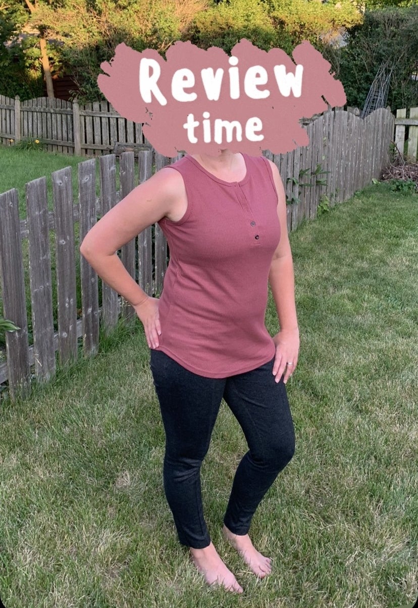 Reviewer posing out in yard in the red henley tank shirt