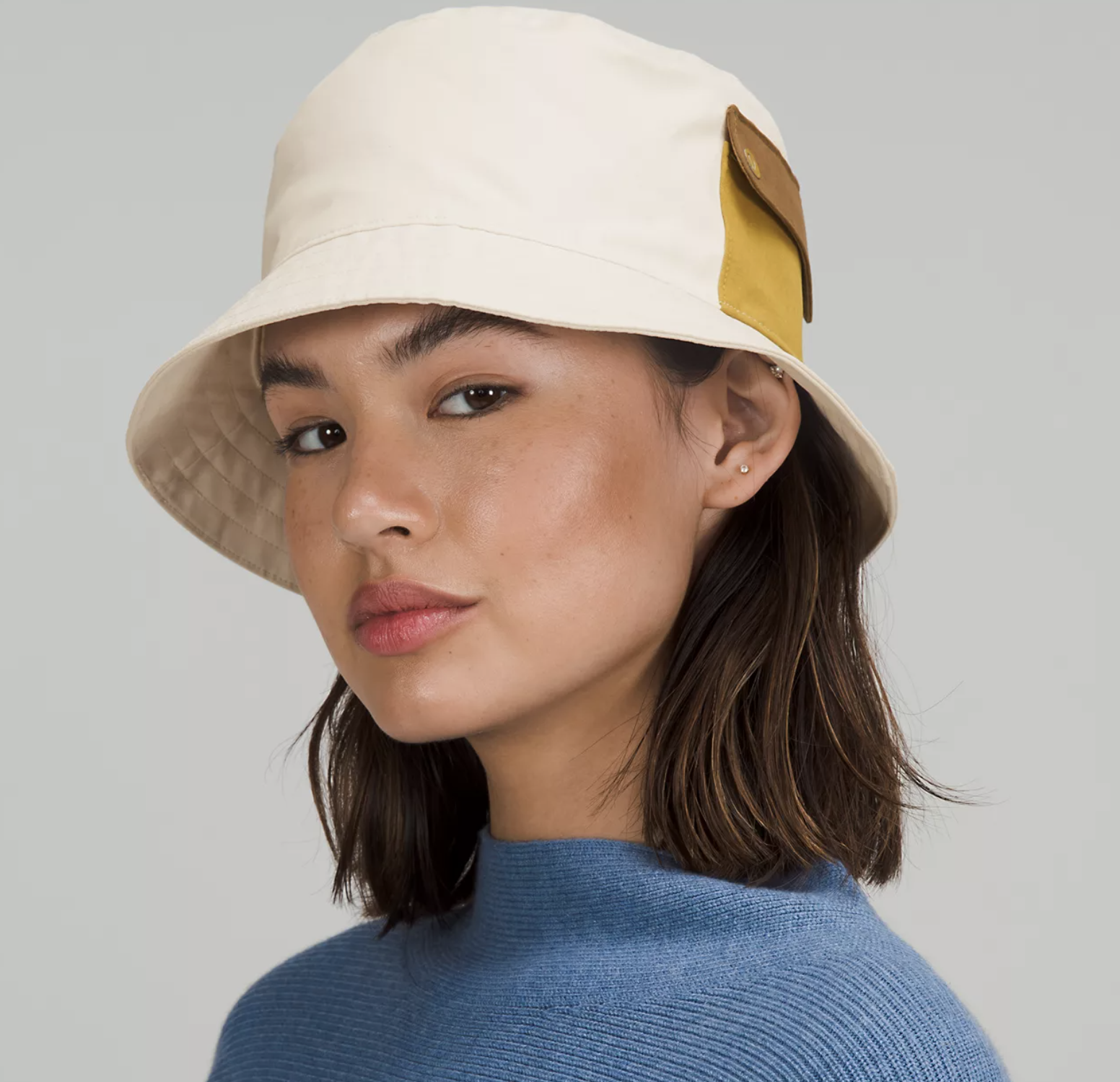 A person wearing the bucket hat with a sweater