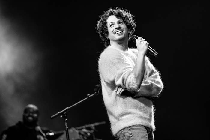 A black and white photo of Charlie Puth performing