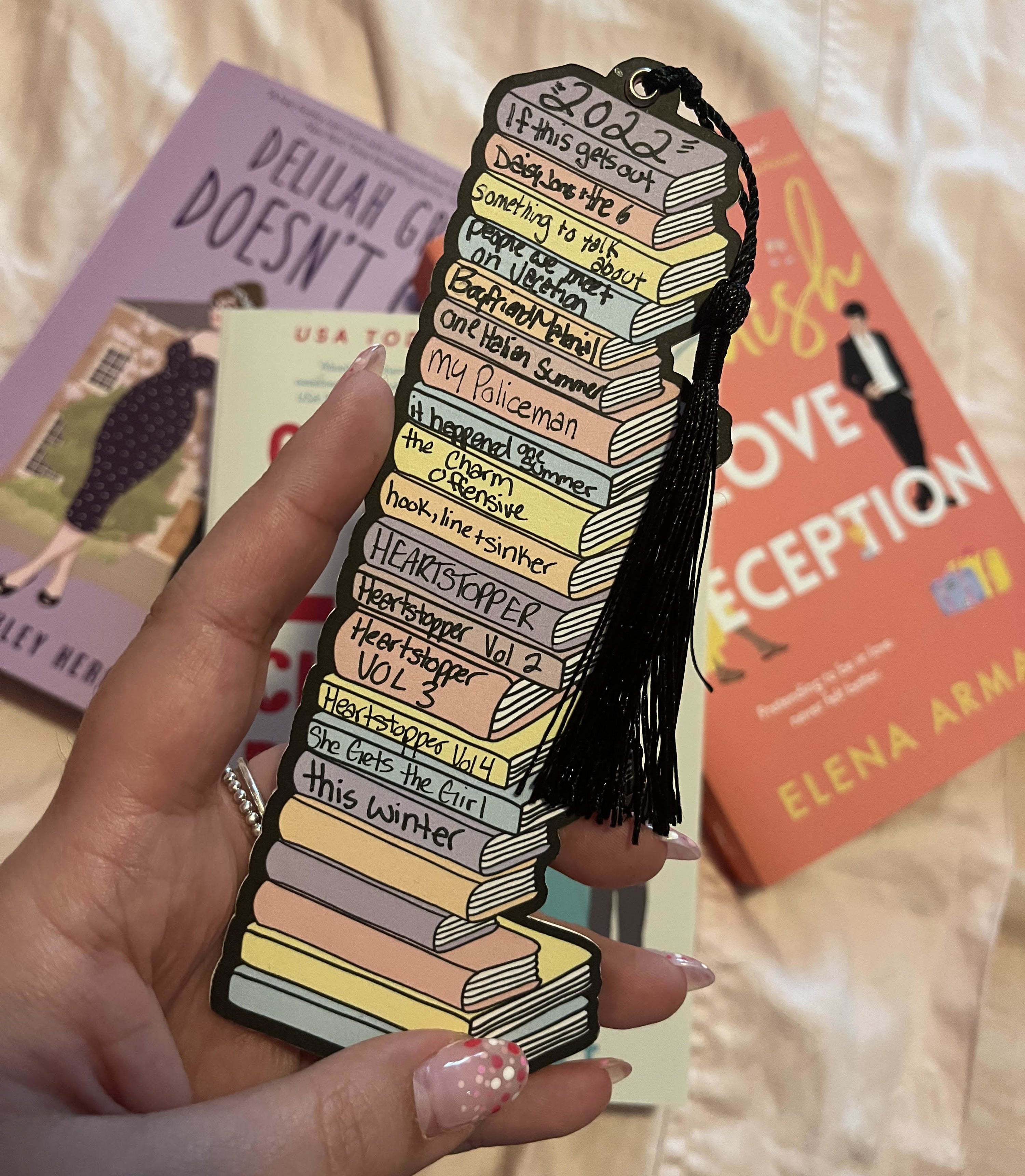 Bianca holding up the bookmark with all of the books she&#x27;s read written on it