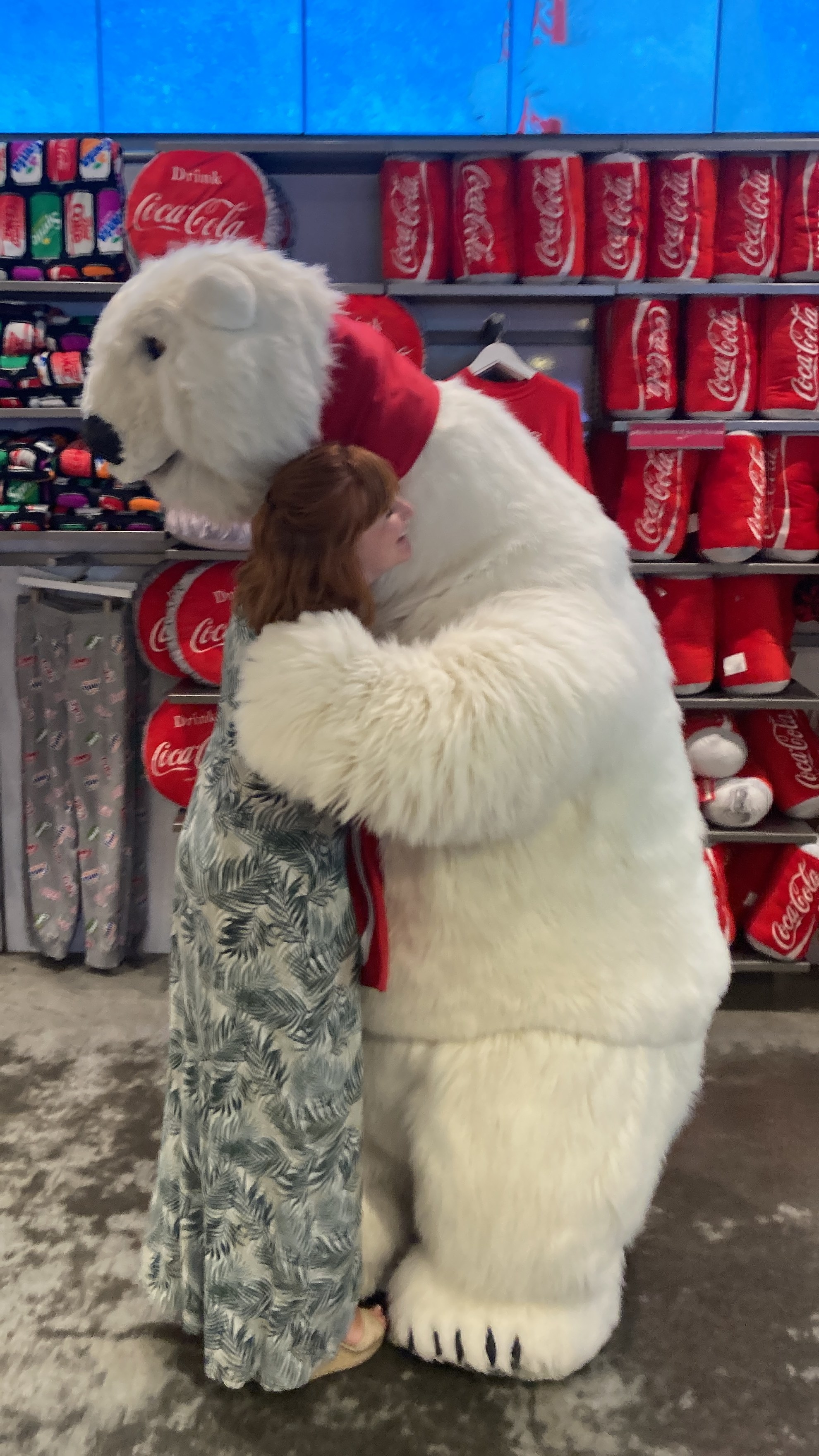 a person hugging the stuffed bear