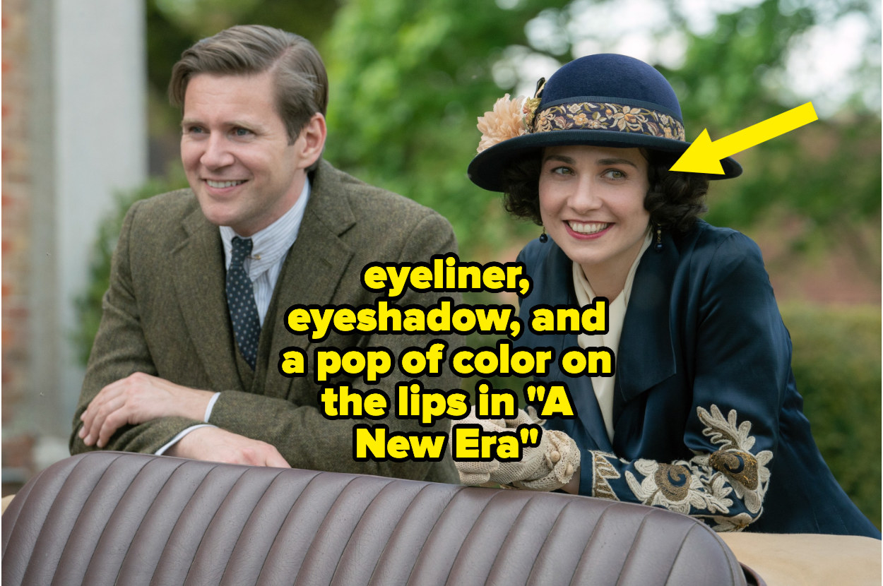 A man and woman smiling in &quot;Downton Abbey: A New Era&quot; with an arrow pointing out the woman is wearing more eyeliner, eyeshadow, and lipstick
