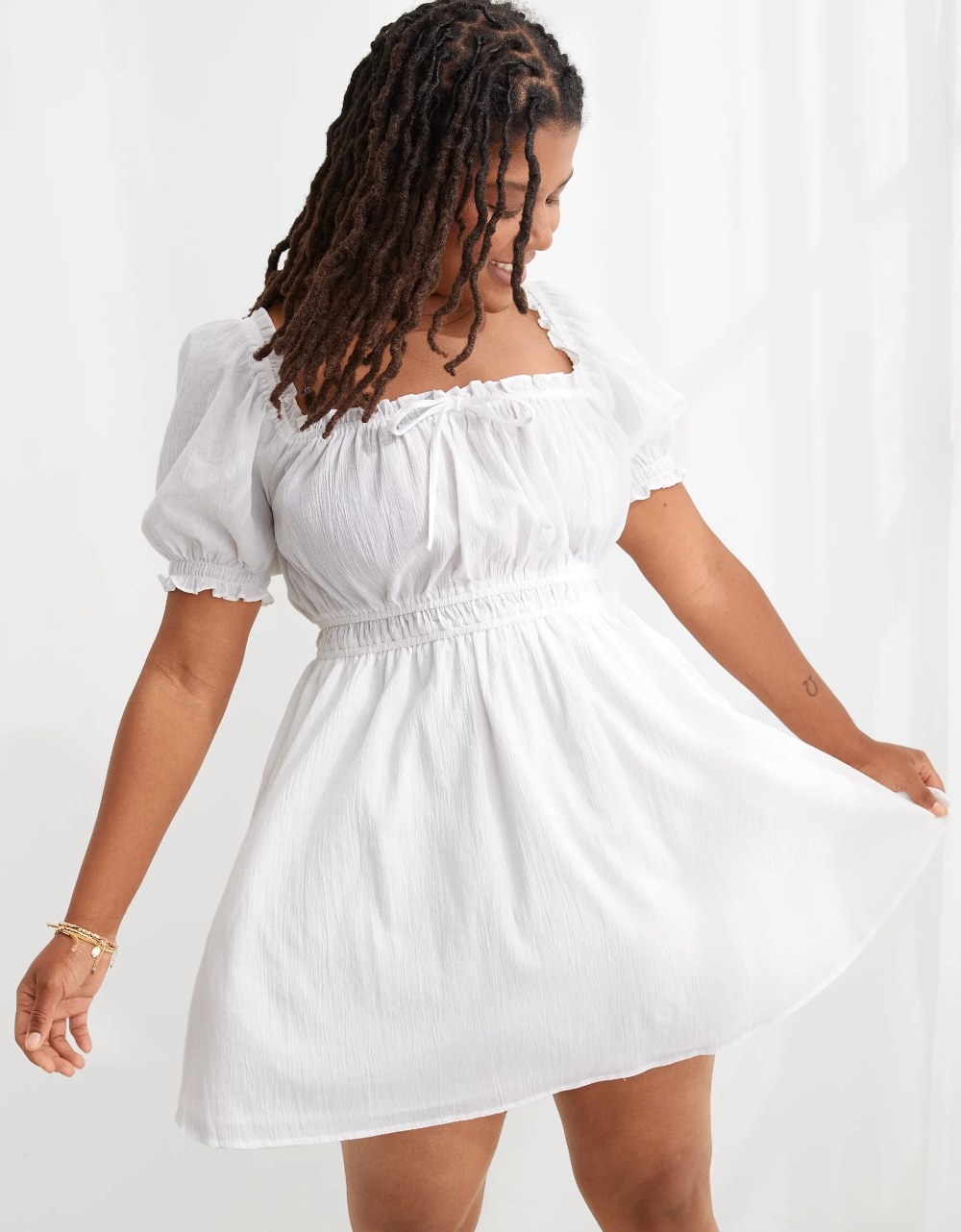 A model wearing the dress in the color White