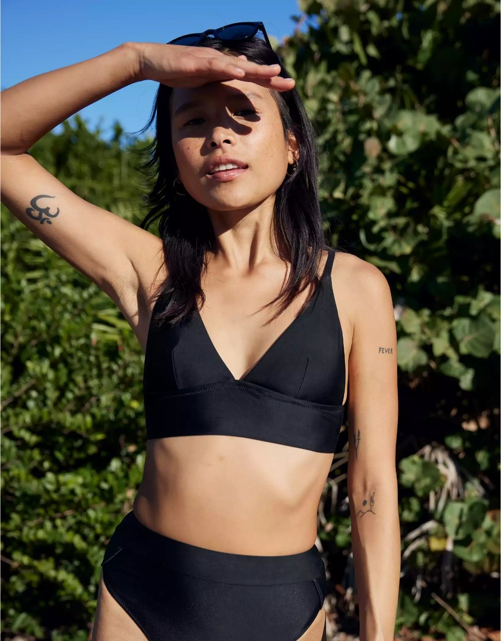 A model wearing the bikini top in the color True Black