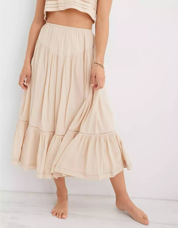 A model wearing the midi skirt in the color Sandalwood