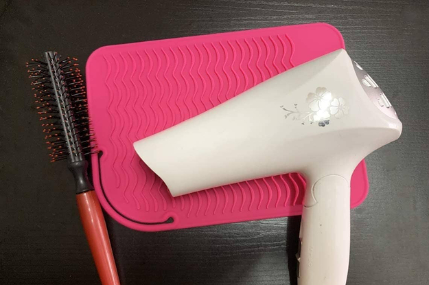 A hot tool mat with a blow dryer on it