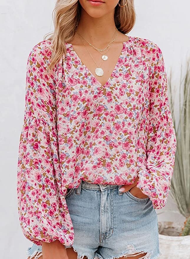 model wearing the floral pink blouse