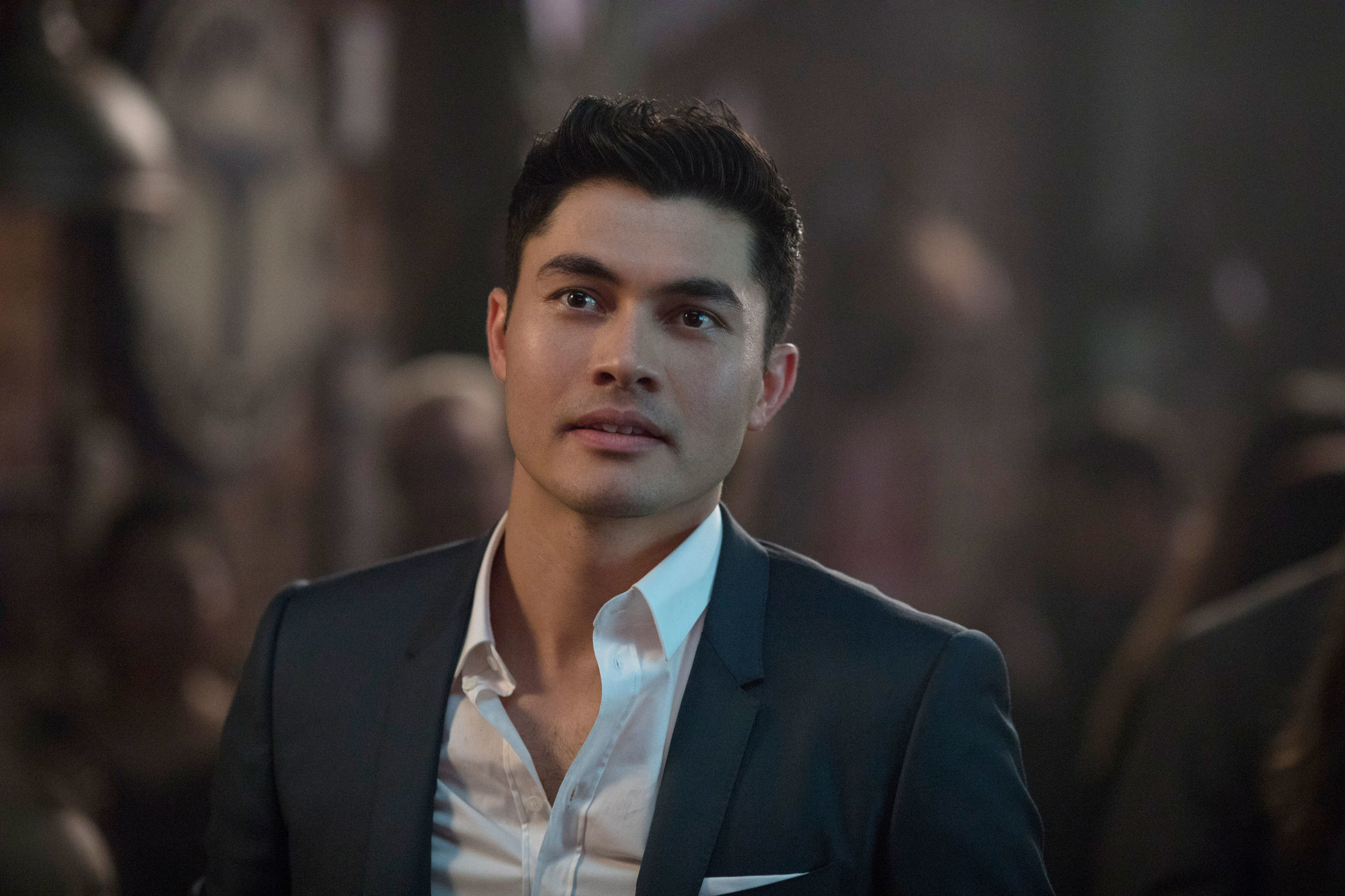 Henry Golding looking handsome in a suit