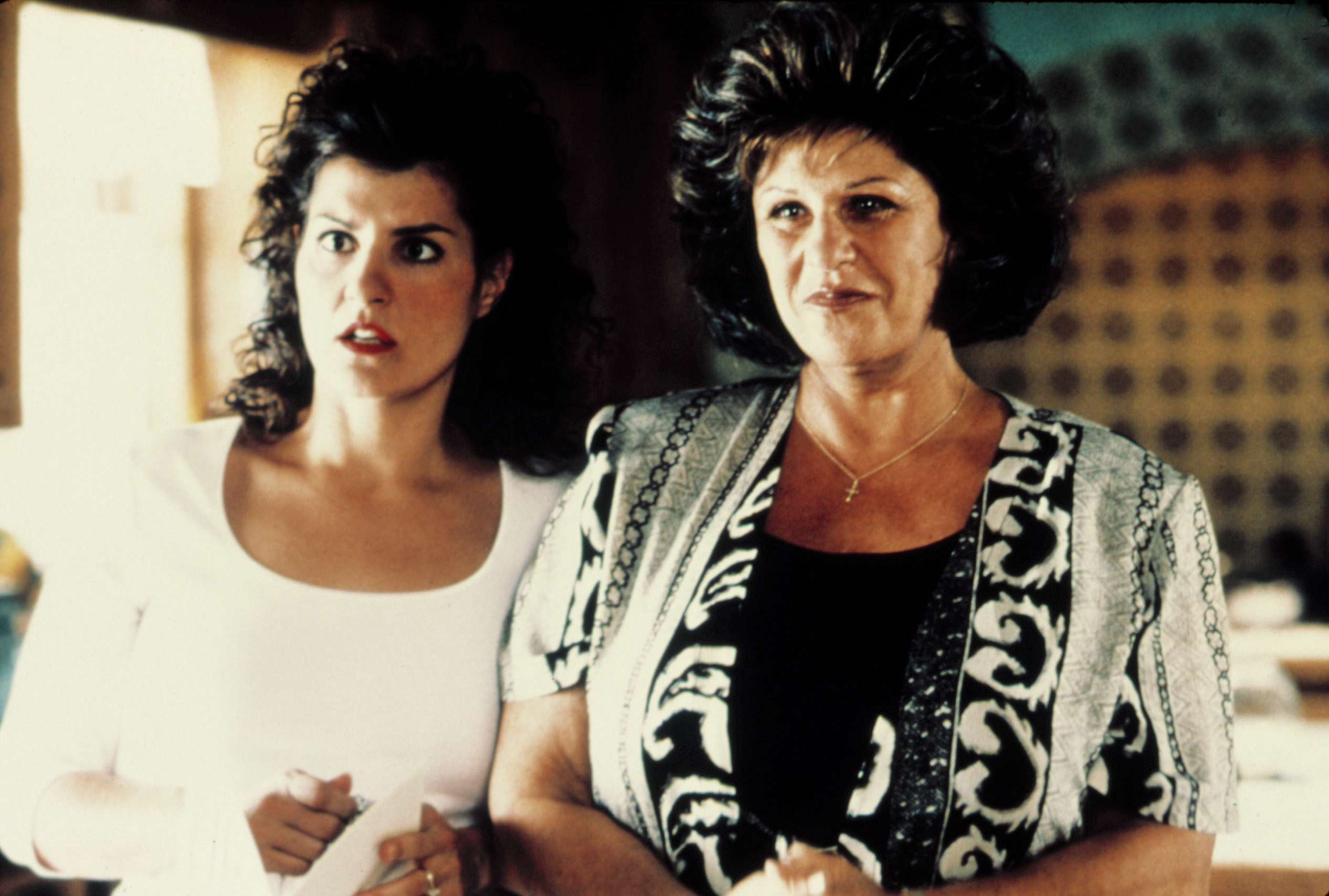 Nia Vardalos and Lainie Kazan stand in their kitchen and look shocked at something offscreen