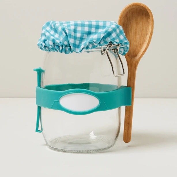 The jar and spoon kit in front of a plain background
