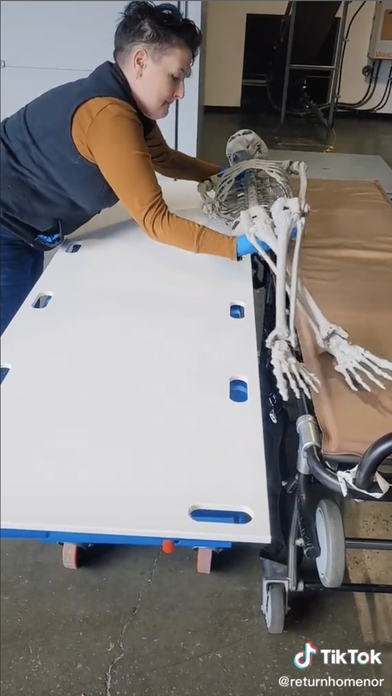 A person from the TikTok transfers a fake skeleton onto a body board