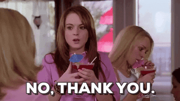 A young woman holding a beverage and saying &quot;No thank you&quot;