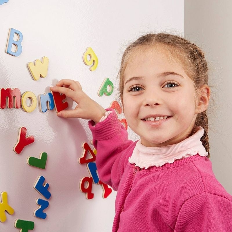 kid using magnet letters and numbers