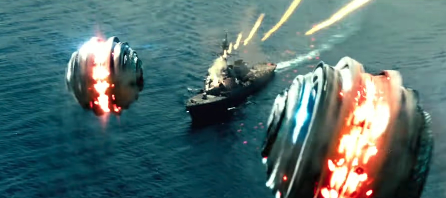 Alien ships speed towards a battleship that sprays bullets at them