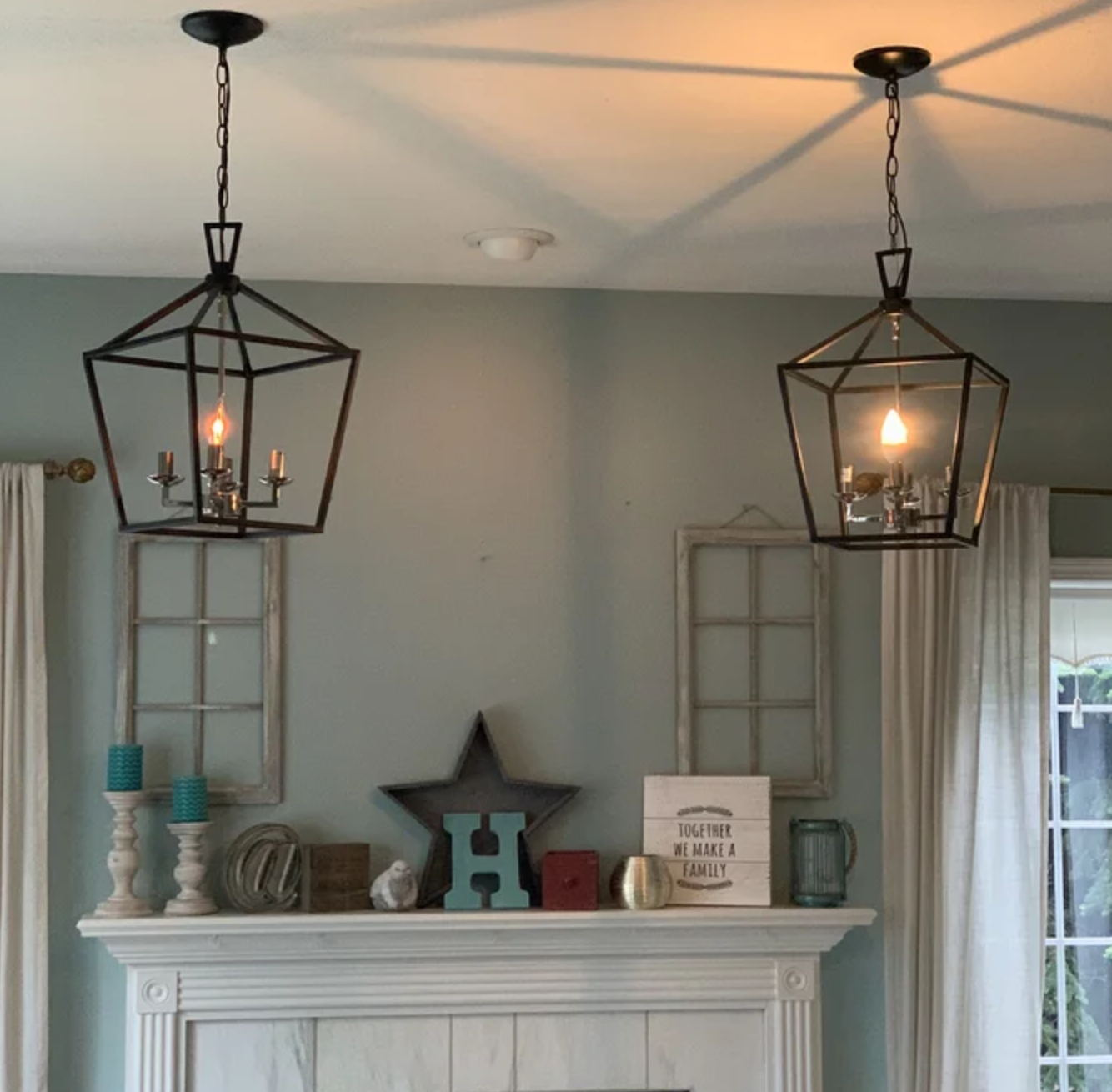 An image of two geometric pendant light inside a living room area