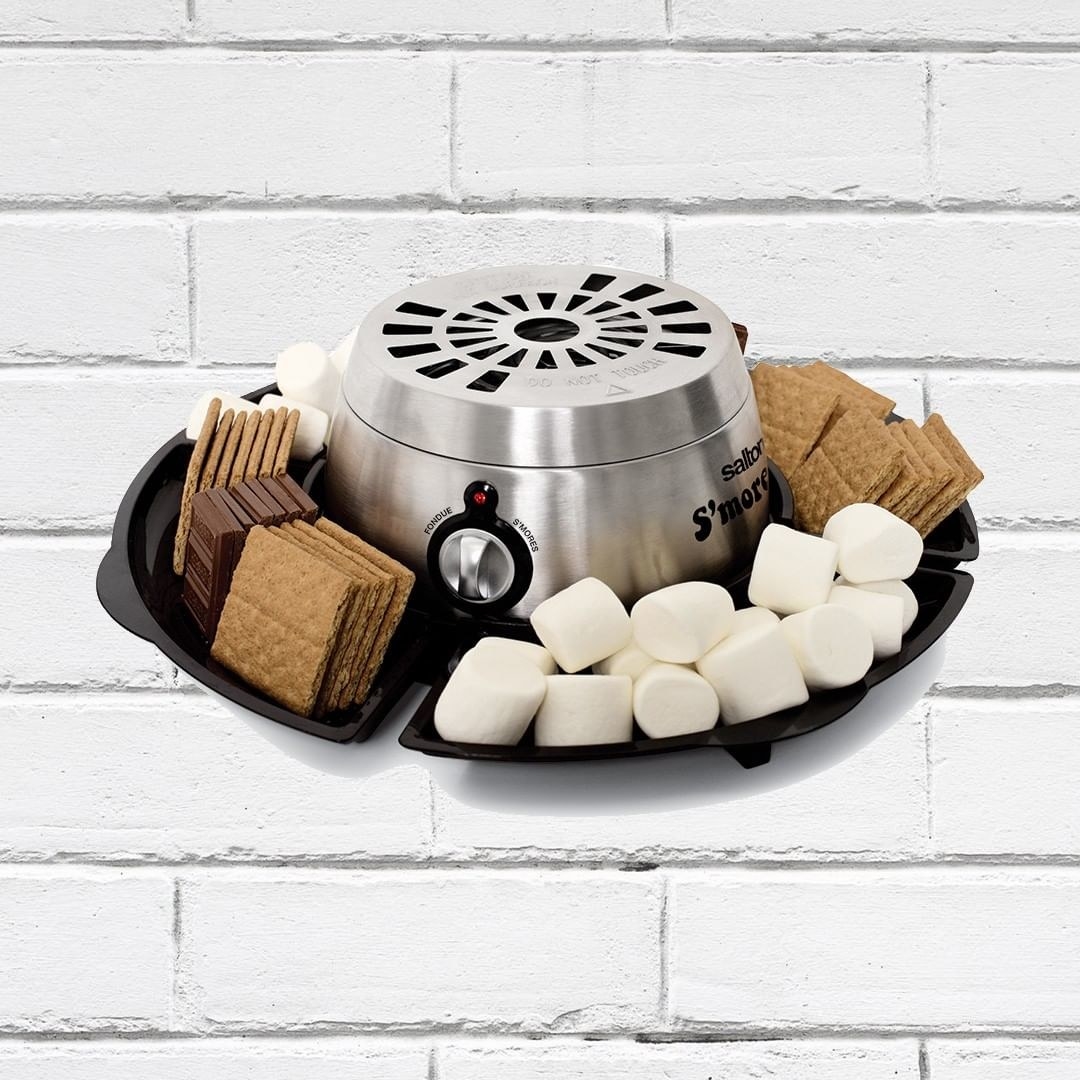 The s'mores maker with graham crackers, marshamllows, and chocolate on its trays