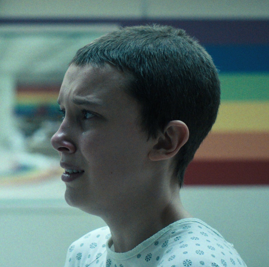 Close-up of an anguished-looking Eleven with shorn hair