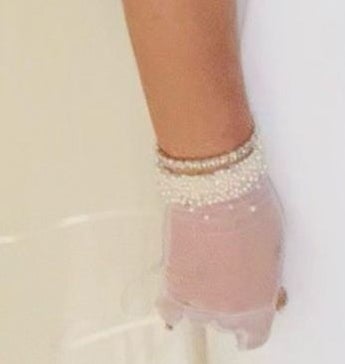 Close-up of bracelet and gloves on Britney&#x27;s arm