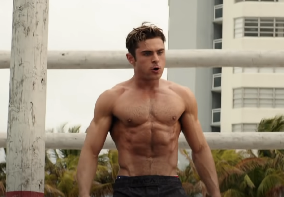 Zac Efron shirtless in Baywatch; his body is toned to an extreme degree