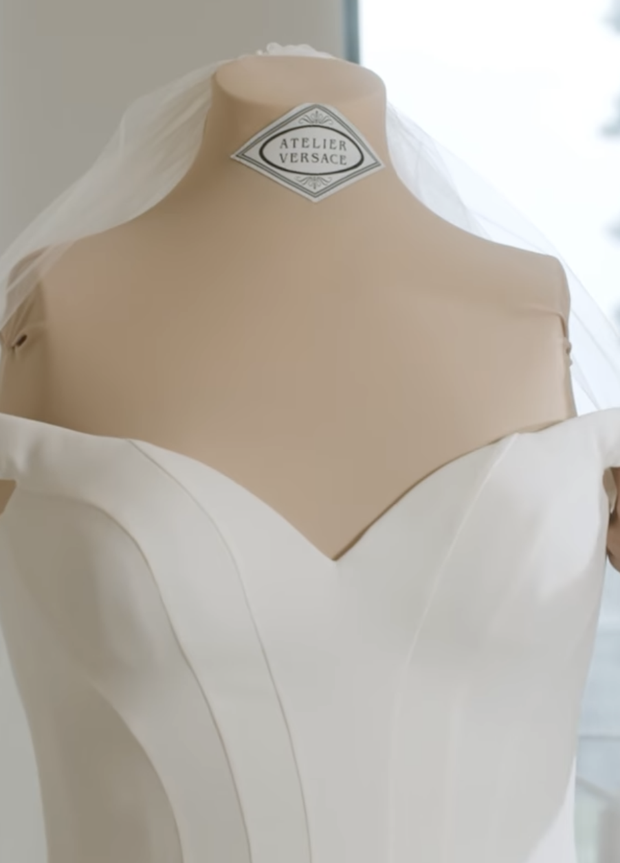 Close-up of dress on a mannequin labeled &quot;Atelier Versace&quot;