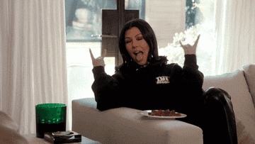 Kourtney Kardashian doing the rock sign with her hands