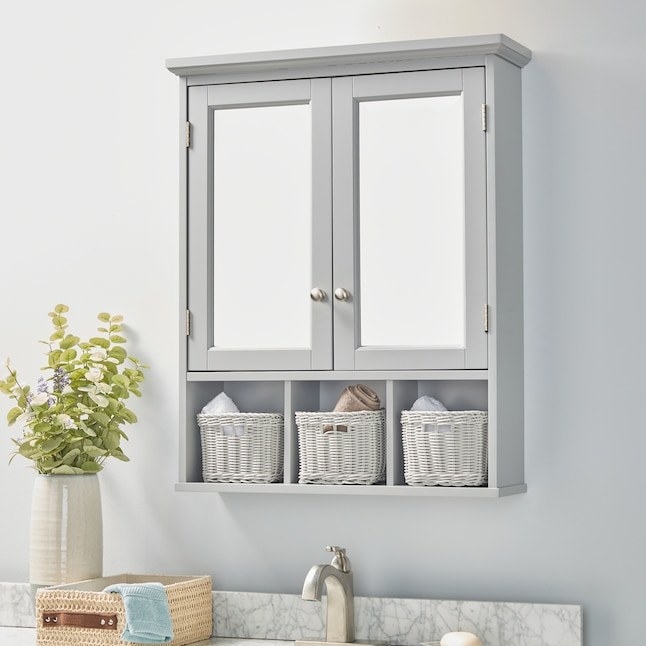 the gray mirrored medicine cabinet with baskets in the cubbies